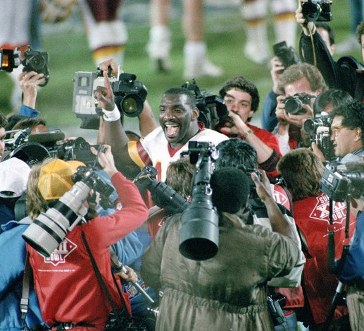 Redskins QB Doug Williams is surrounded by media after the game. (Washington Post)