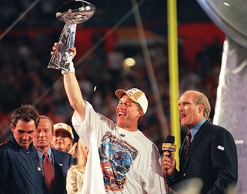 Broncos QB and game MVP John Elway celebrates the victory in his final game. (?)